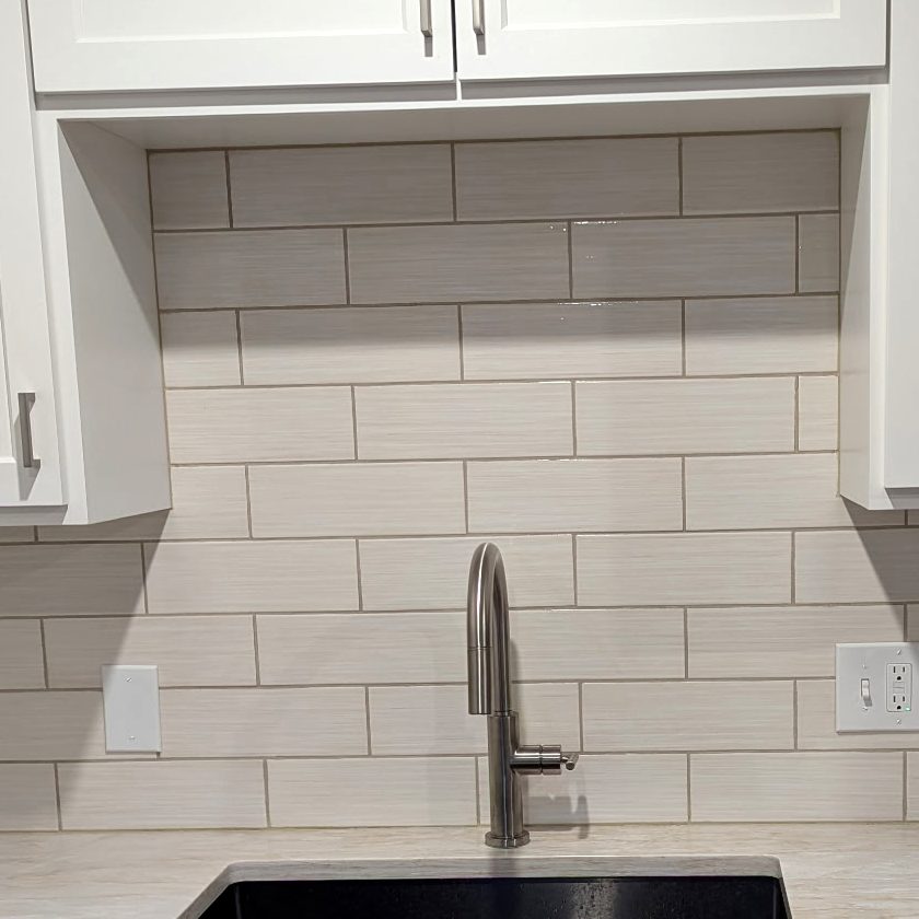 Close view of an open shelf niche built above a kitchen sink