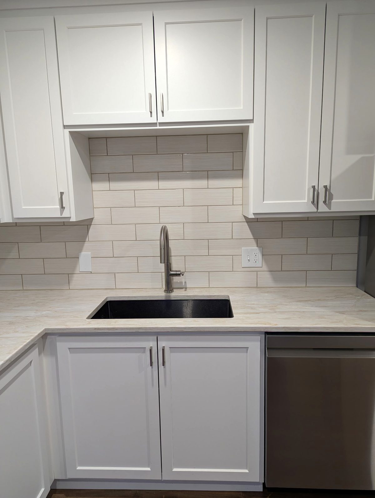 White shaker sink wall with an open niche above the sink and cabinets on both sides